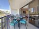 Comfortable outdoor balcony seating features space for dining and relaxing with a view through sliding glass doors at 1581 Gulf Blvd # 102N, Clearwater Beach, FL 33767