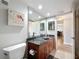 Bathroom features a glass bowl sink, granite countertop, and flamingo art at 1581 Gulf Blvd # 102N, Clearwater Beach, FL 33767