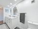 Bathroom features a dual sink vanity, white cabinets, and elegant lighting at 1581 Gulf Blvd # 102N, Clearwater Beach, FL 33767