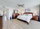 Bedroom features a ceiling fan, hardwood floors, and balcony access at 1581 Gulf Blvd # 102N, Clearwater Beach, FL 33767