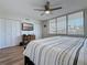 Bright bedroom with large windows, ceiling fan, and flatscreen TV at 1581 Gulf Blvd # 102N, Clearwater Beach, FL 33767