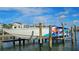 Image of a large boat on a lift, ready for the water, docked behind a home at 1581 Gulf Blvd # 102N, Clearwater Beach, FL 33767