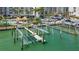 Aerial shot of community boat lift, docks, and boat slips on the water at 1581 Gulf Blvd # 102N, Clearwater Beach, FL 33767