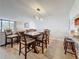 Open-concept dining room features a wooden table with seating for six, and a modern light fixture at 1581 Gulf Blvd # 102N, Clearwater Beach, FL 33767