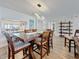 Dining room with seating for six, stone accent wall, and stylish lighting fixture at 1581 Gulf Blvd # 102N, Clearwater Beach, FL 33767