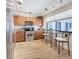 Eat-in kitchen with stainless steel appliances, wood cabinets, and a cozy breakfast nook by the window at 1581 Gulf Blvd # 102N, Clearwater Beach, FL 33767