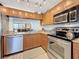 Bright kitchen featuring stainless steel appliances, granite countertops, and a pass-through to the dining area at 1581 Gulf Blvd # 102N, Clearwater Beach, FL 33767
