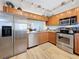 Modern kitchen with stainless steel appliances, granite countertops, and wood cabinets at 1581 Gulf Blvd # 102N, Clearwater Beach, FL 33767