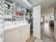 Interior laundry closet with washer, dryer, and storage shelving at 1581 Gulf Blvd # 102N, Clearwater Beach, FL 33767