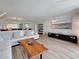 Open-concept living room features a large stone accent wall, and comfortable seating at 1581 Gulf Blvd # 102N, Clearwater Beach, FL 33767
