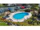 View of pool surrounded by lounge chairs, tiki umbrellas and lush greenery and landscaping at 1581 Gulf Blvd # 102N, Clearwater Beach, FL 33767