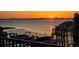Water view from a balcony of the sunset over a community boat dock and boat slips at 1581 Gulf Blvd # 102N, Clearwater Beach, FL 33767