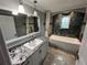 Bathroom showcasing a soaking tub, designer tile and granite counters at 200 4Th S Ave # 231, St Petersburg, FL 33701