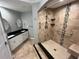 Bathroom highlighting a tiled shower with bench, and a black granite double sink at 200 4Th S Ave # 231, St Petersburg, FL 33701