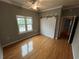 Bedroom with wood floors, ceiling fan, a window, and a sliding barn door closet at 200 4Th S Ave # 231, St Petersburg, FL 33701
