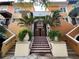 Inviting building entrance with tiled stairs, potted plants, and decorative ironwork at 200 4Th S Ave # 231, St Petersburg, FL 33701