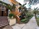 Two-story property featuring lush landscaping, tiled stairs, and a charming entrance at 200 4Th S Ave # 231, St Petersburg, FL 33701