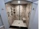 Modern tiled shower showcasing grab bars and convenient built-in shelving at 200 4Th S Ave # 231, St Petersburg, FL 33701