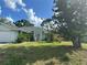 Charming single-story home featuring a well-maintained lawn and beautiful landscaping at 21285 Peachland Blvd, Port Charlotte, FL 33954