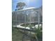 Screened-in pool with ladder and concrete edging at 21285 Peachland Blvd, Port Charlotte, FL 33954
