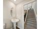 Convenient powder room with a pedestal sink and neutral décor at 8364 Capstone Ranch Dr, New Port Richey, FL 34655