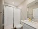 Bathroom featuring a glass shower, white tiling, and a modern vanity with quartz countertops at 8364 Capstone Ranch Dr, New Port Richey, FL 34655