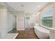 Modern bathroom featuring a soaking tub, separate shower, and beautiful tile work at 8364 Capstone Ranch Dr, New Port Richey, FL 34655