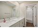 Bathroom featuring a double sink vanity with quartz countertop and a view of the shower at 8364 Capstone Ranch Dr, New Port Richey, FL 34655