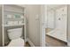 Bathroom featuring a modern shower with white tiling and a convenient toilet with built-in shelving at 8364 Capstone Ranch Dr, New Port Richey, FL 34655