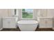 Elegant bathroom with a freestanding tub, dual vanities, and modern design at 8364 Capstone Ranch Dr, New Port Richey, FL 34655