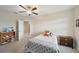 Bedroom featuring a bed, ceiling fan, bookshelf, and a view into the hallway at 8364 Capstone Ranch Dr, New Port Richey, FL 34655