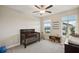 Bedroom featuring a crib, ceiling fan, rocking chair, and two bright windows at 8364 Capstone Ranch Dr, New Port Richey, FL 34655