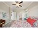 Cozy bedroom featuring a ceiling fan, colorful bedding, and private access to the bathroom at 8364 Capstone Ranch Dr, New Port Richey, FL 34655