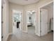 Hallway featuring carpeted floors and multiple doorways leading to bedrooms at 8364 Capstone Ranch Dr, New Port Richey, FL 34655