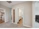 Hallway featuring carpeted floors, leading to laundry room, bathroom, and bedroom at 8364 Capstone Ranch Dr, New Port Richey, FL 34655