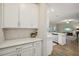 Open concept kitchen featuring white cabinetry, stainless appliances, and views into the living room at 8364 Capstone Ranch Dr, New Port Richey, FL 34655
