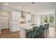 Bright kitchen with white cabinets, stainless steel appliances and large center island at 8364 Capstone Ranch Dr, New Port Richey, FL 34655
