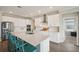 Bright kitchen with white cabinets, stainless steel appliances and large island with seating at 8364 Capstone Ranch Dr, New Port Richey, FL 34655