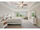 Serene main bedroom with tray ceilings, large windows, and plush carpeting at 8364 Capstone Ranch Dr, New Port Richey, FL 34655