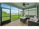 Screened patio with brick pavers, ceiling fan, and seating offers tranquil water views at 8364 Capstone Ranch Dr, New Port Richey, FL 34655