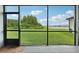 Screened patio overlooking lush backyard offers tranquil views of the lake and landscape at 8364 Capstone Ranch Dr, New Port Richey, FL 34655