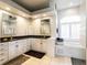 Elegant bathroom with dual sinks, white cabinetry, and a luxurious soaking tub beneath a window at 1647 Stable Trl, Palm Harbor, FL 34685