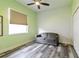 Cozy bedroom with a textured wall, soft lighting, and a comfortable gray sofa at 1647 Stable Trl, Palm Harbor, FL 34685
