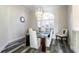 Bright dining room features hardwood floors and lots of natural light from the large window with plantation shutters at 1647 Stable Trl, Palm Harbor, FL 34685
