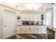 Stylish kitchen with white cabinets, granite countertops, and stainless steel appliances at 1647 Stable Trl, Palm Harbor, FL 34685