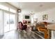 Bright living room featuring a fireplace, TV, and sliding glass doors to the outdoor patio at 1647 Stable Trl, Palm Harbor, FL 34685