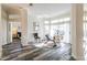 Sun-filled living room with hardwood floors, large windows, and backyard access at 1647 Stable Trl, Palm Harbor, FL 34685