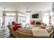 Spacious living room with a fireplace, TV, and sliding glass doors leading to the outdoor pool area at 1647 Stable Trl, Palm Harbor, FL 34685