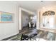 Open-concept living room with hardwood floors, dining area, and natural lighting at 1647 Stable Trl, Palm Harbor, FL 34685