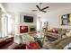 Inviting living room with a fireplace, large TV, and colorful rug that adds a vibrant touch at 1647 Stable Trl, Palm Harbor, FL 34685